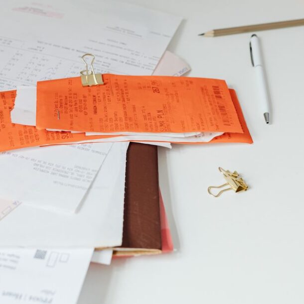 stack of invoices paperwork desk